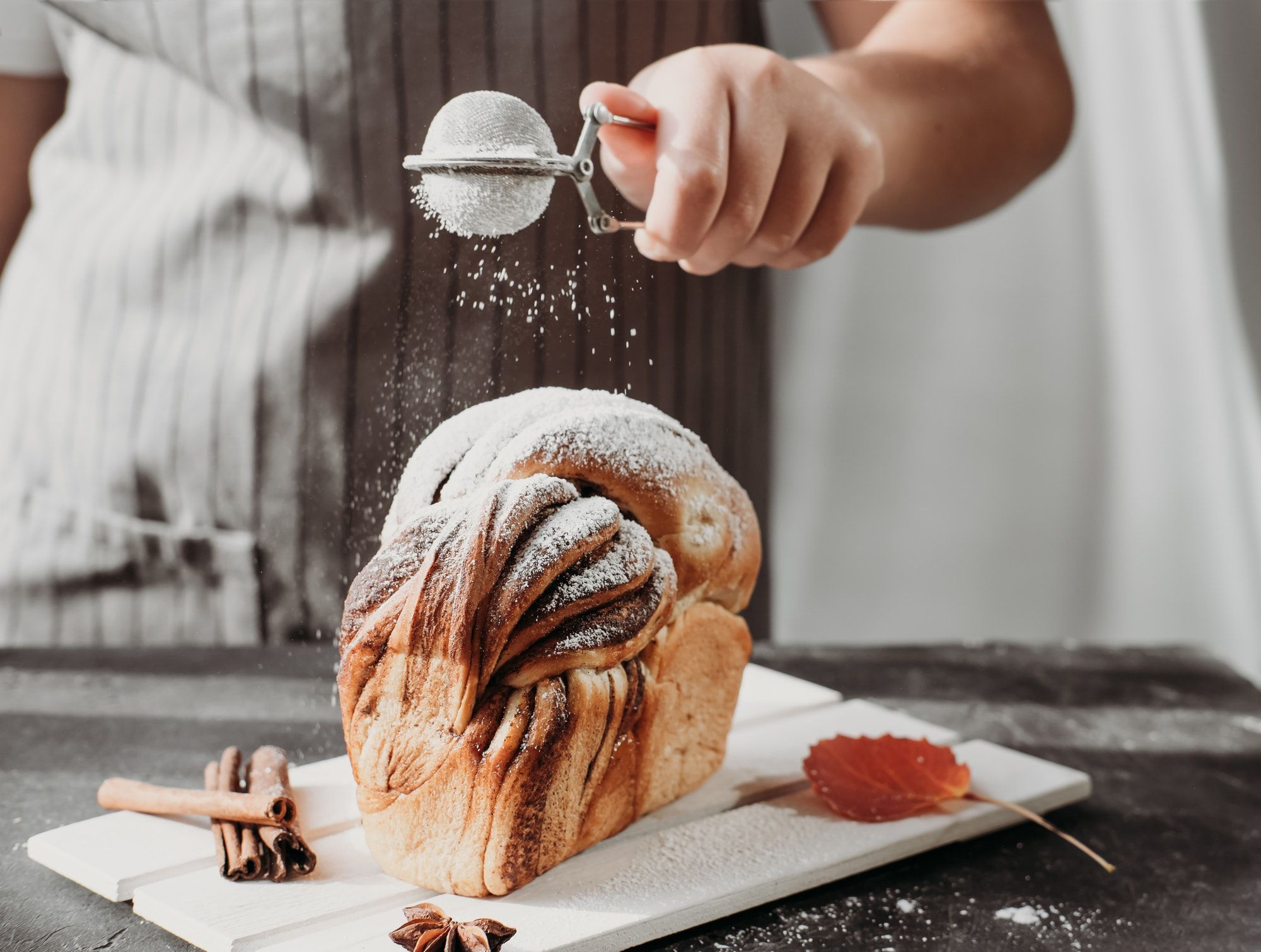 artisan sourdough cinnamon swirl bread on wooden rack.jpg